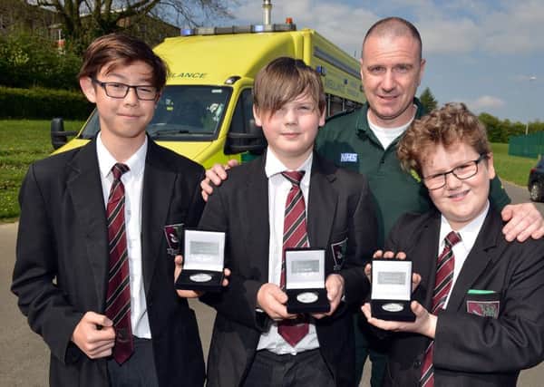 Students from Brookfield Community School receive the Laverick Award from East Midlands Ambulance Service for saving a man that fell in the river at Somersall Park, pictured from left are Joe Davis, George Beresford, heart teamleader Grant Whiteside and Louie Grayson