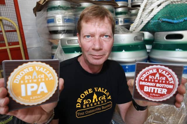 Jez Horton with some of the brewerys pump clips.
