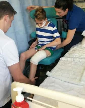 Joe Boyer, 14, pictured in hospital after being hit by a motorbike.