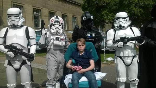 Joe Boyer, 14, pictured in his chair outside the hospital after serious crash in Staveley.