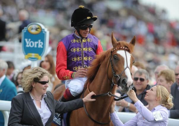 BY ROYAL APPOINTMENT -- Frankie Dettori sporting the royal silks on a winner owned by The Queen. Jockey, colours and owner are sure to be to the fore at Royal Ascot next week.