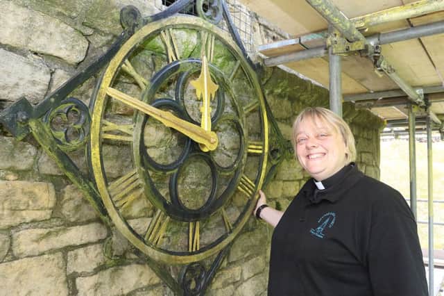 Rev Rachel Gouldthorpe with one of the three clock faces that will be restored as part of the project