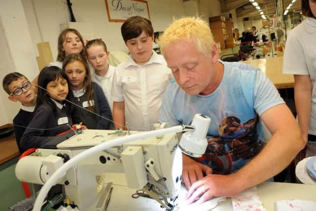 David Nieper, Fashion for Free.Local school children are given lessons from sample machinist Andrew Dooley at the David Nieper factory in Alfreton on Wednesday.