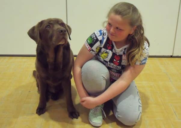 Sienna Alsop is pictured with Cola, owned by Bolsover Drama Group members Lisa and Lianne Brunt.