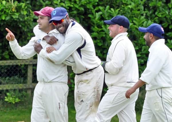 WELL HELD! -- teammates congratulate Retford's Kamran Afzaal after he had taken a catch to dismiss Papplewick and Linby batsman James Taylor.