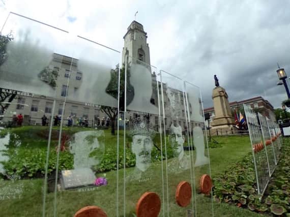 Barnsley Pals faces of Somme victims engraved on panels which will be lit at night outside the Town Hall.