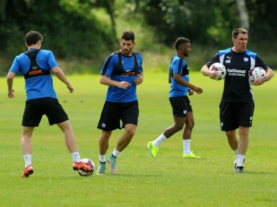Ched Evans carries out a training drill, overseen by coach and former Sheffield United team mate Chris Morgan