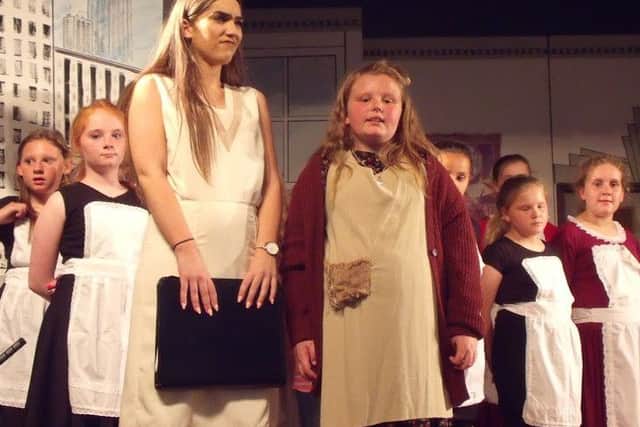 Sienna Alsop as Annie with Charlotte Blunt playing Grace in Annie, presented by Bolsover Drama Group's youth section.