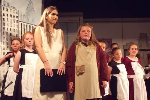 Sienna Alsop as Annie with Charlotte Blunt playing Grace in Annie, presented by Bolsover Drama Group's youth section.
