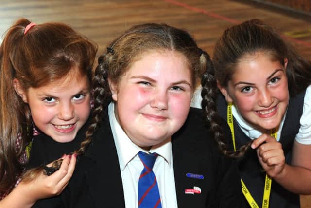 Millie-May Leder gets some support for her sponsored head shave from twin sisters, Jorja and Sophie.