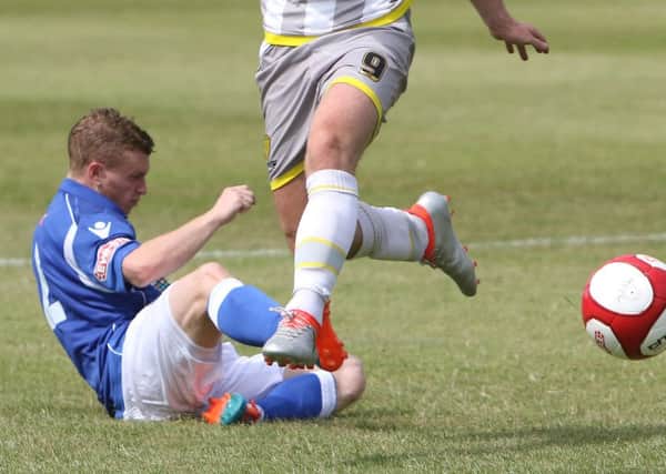Matlock Town v Burton Albion, Jamie Yates makes a crunching tackle