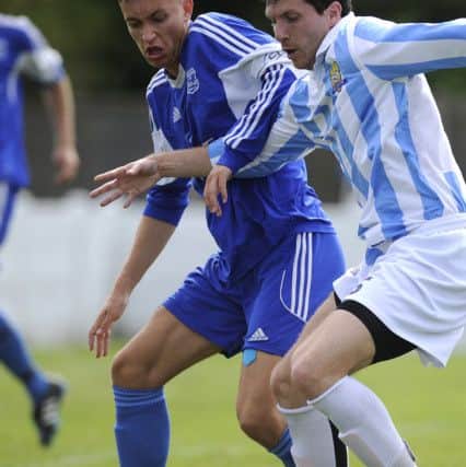 Jake Ballinger in the blue and white stripes of FC Bolsover.