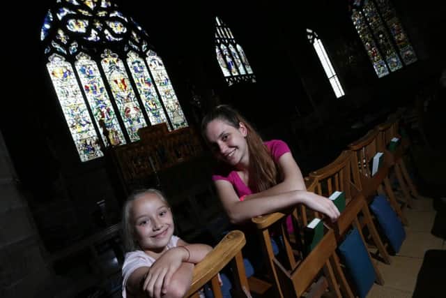 Karina Kesareva, eight, and Victoria Belousova, 16, at the Church Spire. Picture: Mark Fear.