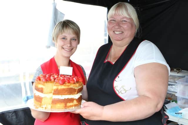 Zoe Crawley and Tracey Stoddart, of Bolsover's Ooh La La, with a tasty cake.