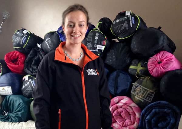 Rebecca Hancock with the sleeping bags which have been donated for the homeless.
