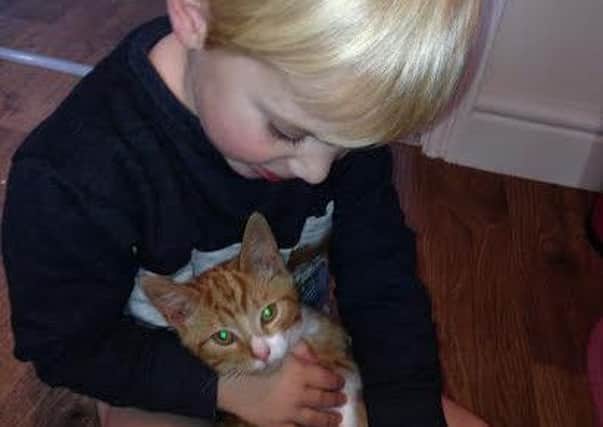 Lucas with his pet cat Leo.