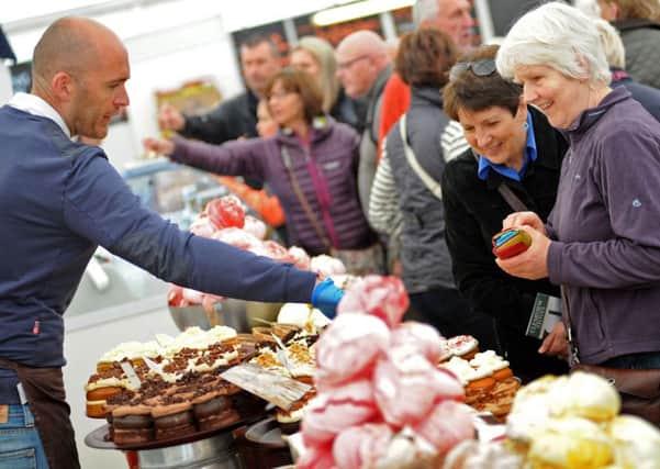Chatsworth Country Fair.        
Visitors buy sweet treats from the food hall.