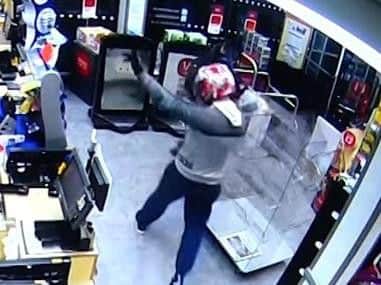 He is then shown waving to his victim as he leaves the shop.