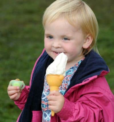 Three-year-old Isabel Bromilow enjoys an ice cream at the show.