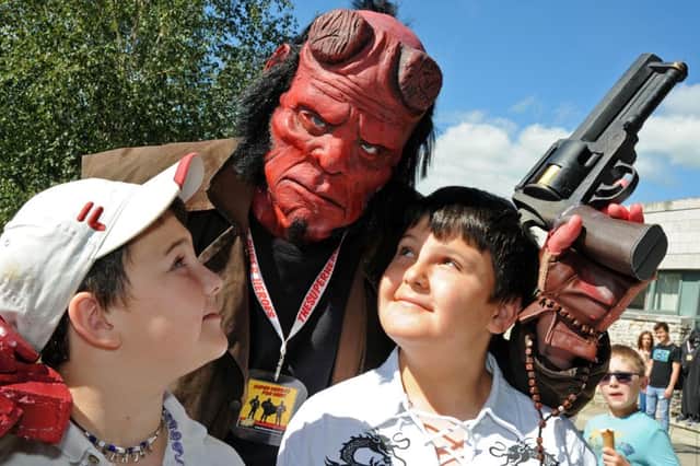 TJ and Brandon Knight make friends with Hell Boy at the Comic-Con event.