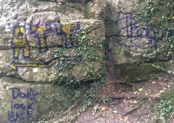 Graffiti 'tags' on a Matlock path.