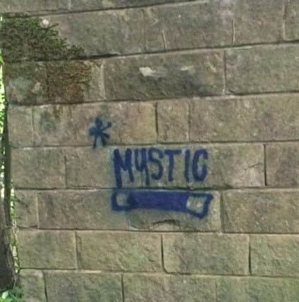 Graffiti 'tags' on a Matlock path. The word 'mysitic' is thought to reference a PokemonGo 'team'.