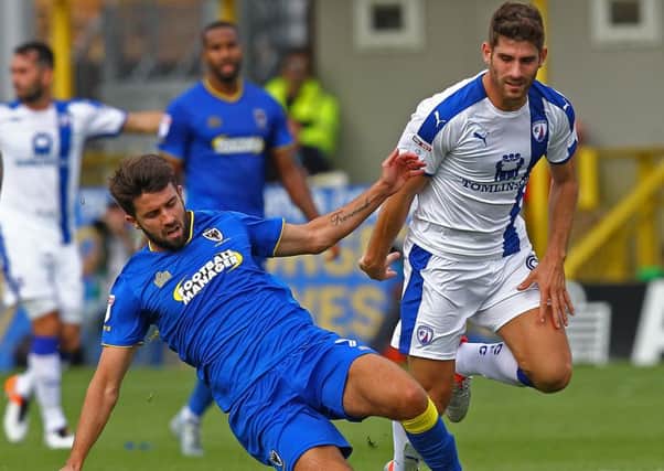 Picture by Gareth Williams/AHPIX.com. Football, Sky Bet League One; 
AFC Wimbledon v Chesterfield; 03/09/2016 KO 3.00pm;  
The Cherry Red Records Stadium;
copyright picture;Howard Roe/AHPIX.com
AFC Wimbledon's George Francomb slides in to halt the progress of Chesterfield's Ched Evans
