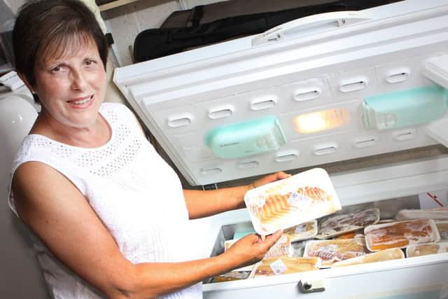 Maureen Jordan with the freezer full of fish bought by her brother Paul Eastburn who has dementia