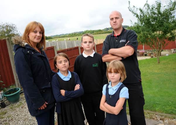The Poulton family who live on Mansfield Road in Hasland and are unhappy, along with other residents, with proposals to build homes on the field adjacent to their back gardens.  Pictured are from left, mum Lynsey, Emma 9, Luke 12, 8 year old Devon and dad Ben.