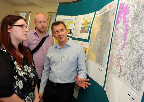 John Barraclough, right, from the Environment Agency, chats with Dronfield residents, John and Hayley Roebuck-Wilson during the fracking drop-in event held at the Peel Centre.