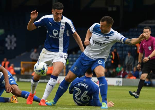 Chesterfield's Conor Wilkinson is tackled by Bury's Antony Kay. Pic by Andrew Roe.