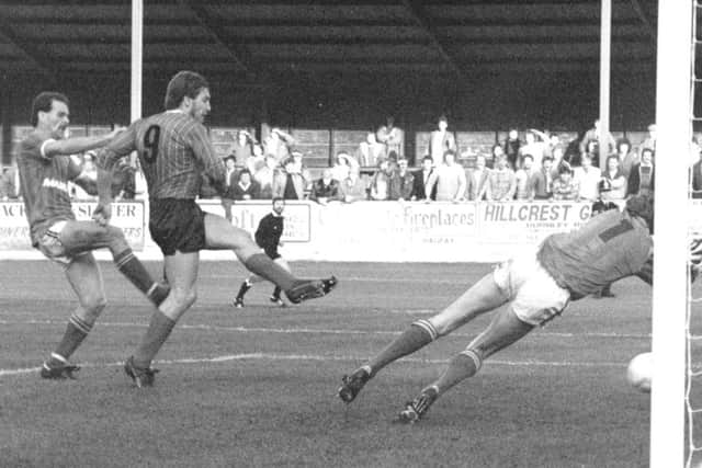 Bob Newton crashes the ball home after Halifax keeper Paddy Roche saved his penalty, in Town's 3-1 win over the West Yorkshire side