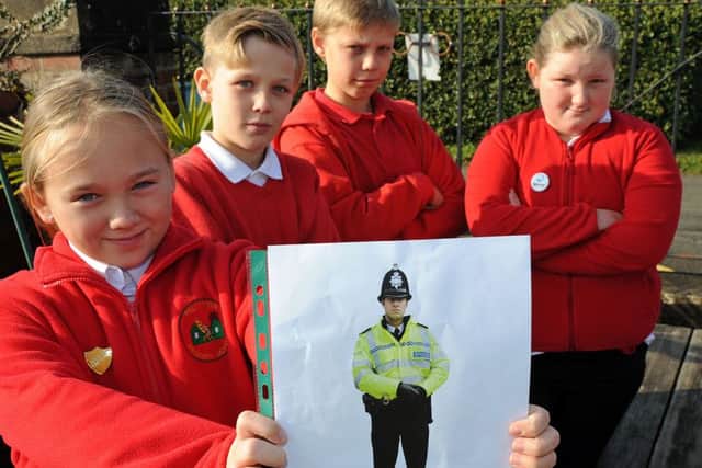 Have you seen this man?  Pupils, Holly, Jacob, Oscar and Amelia, from Palterton Primary School are wanting to know who took their cardboard cut-out of police officer Graham, which stood in their playground.