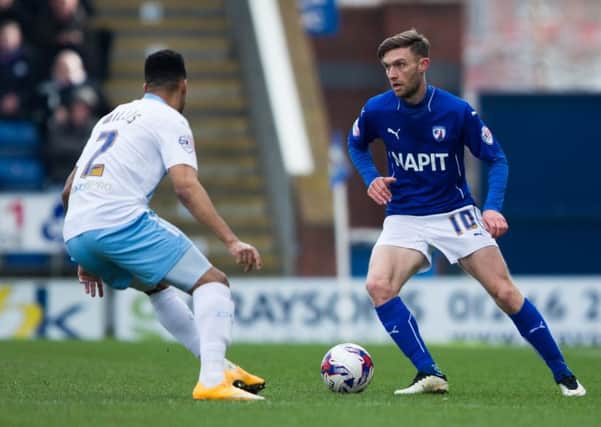 Chesterfield vs Coventry - Jay O'Shea brings the ball forward as coventry's Jordan Willis closes in - Pic By James Williamson