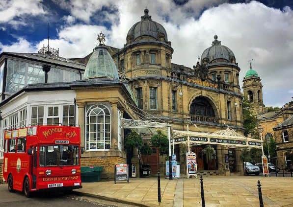 Buxton Opera House and the converted milk float tram which takes people on tours of the tour with Discover Buxton