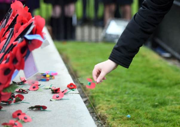 POIGNANT POPPIES -- Remembrance Sunday turned into a sombre occasion for racegoers at Cheltenham's Open meeting.