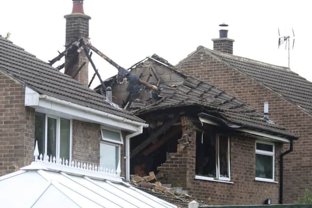 Fire damage is visible at the rear of a house, in Riddings, near Alfreton, Derbyshire, where a suspected gas explosion took place in the early hours of Sunday 20 September 2015. It is thought that there could have been people in the house when the fire started.