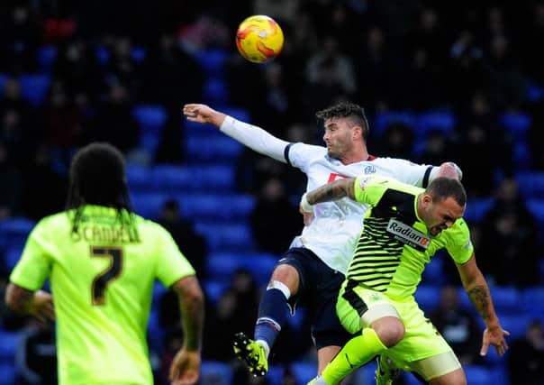 Gary Madine beats Joel Lynch to a high ball.
Bolton Wanderers v Huddersfield Town.  SkyBet Championship.  1 January 2016.  Picture Bruce Rollinson