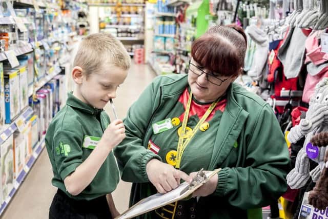 Mr 5 and Pets at Home employee Catherine Murphy sorting out his job sheet.