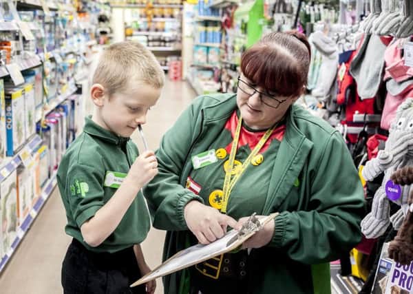 Mr 5 and Pets at Home employee Catherine Murphy sorting out his job sheet.