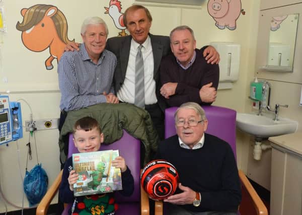 Sunderland legends, back from left,  Jimmy Montgomery, Dick Malone, Kevin Ball and Bobby Kerr with Andrew Taylor, 10, at Sunderland Royal Hospital.