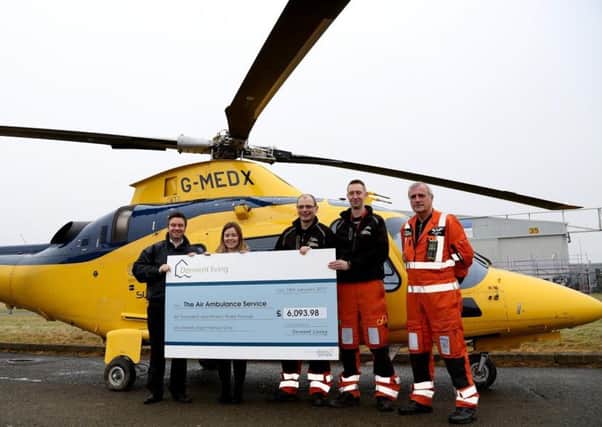 Pictured, left to right, are Mitchell Allseybrook, Harriet Phillipson, Dr Mark Folman, Paramedic Steve Dick and Pilot John Murray during a donation to Derbyshire, Leicestershire and Rutland Air Ambulance from Derwent Living.