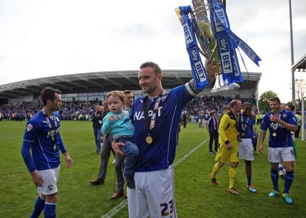 Chesterfield v Fleetwood Town. Players celebrate after Chesterfield won the League 2 Championship. Captain Ian Evatt with the trophy