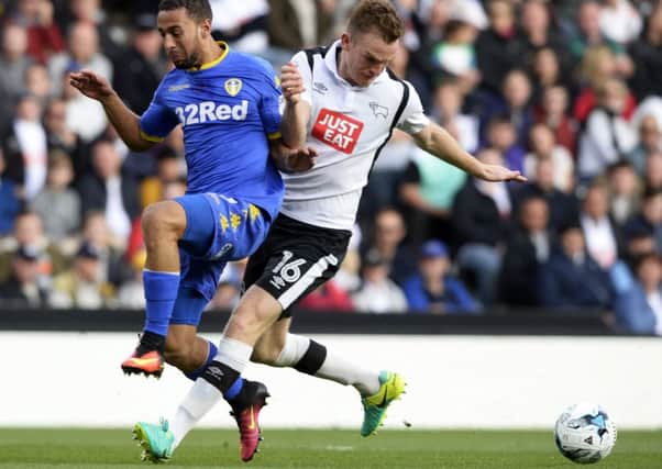 Kemar Roofe is pushed off the ball by Alex Pearce.
Derby County v Leeds United.  Ipro Stadium.  SkyBet Championship.  15 October 2016.  Picture Bruce Rollinson