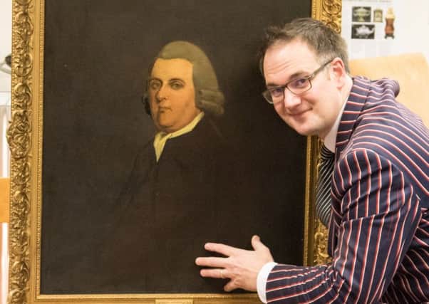 Charles Hansons, manager of Hansons Auctioneers, beside the Joseph Wright painting .