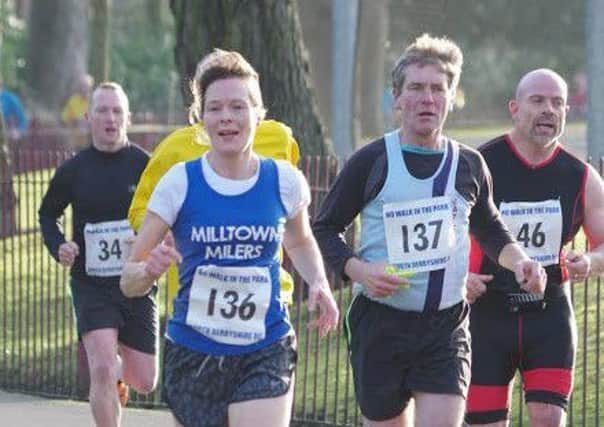 Mick Kuszynski, of Matlock Athletics Club, just behind Joanne Grant, of Milltown Millers, in the No Walk In The Park 5k race at Queens Park, Chesterfield last Saturday.
