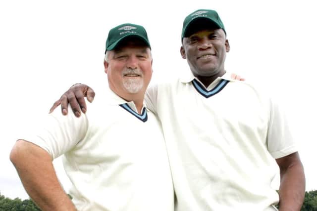 Derbyshire legend Devon Malcolm pictured with former England captain Mike Gatting at a charity match in 2006.