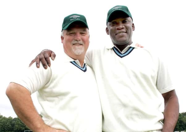 Derbyshire legend Devon Malcolm pictured with former England captain Mike Gatting at a charity match in 2006.