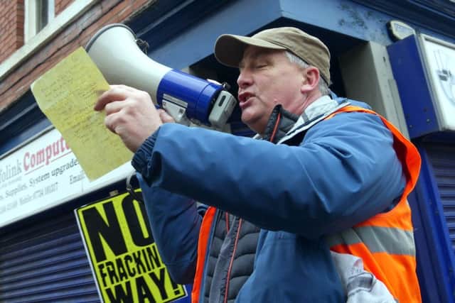 Campaigners address the crowds who have gathered to march against fracking in Derbyshire