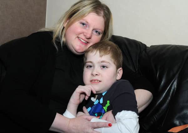 Eleven year old Owen Porter who is taking Network Rail to court over the lack of disabled access at Alfreton train station, with his mum Tara at their South Normanton home.